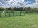 A view of the grassy yard of the home with a metal fence in the background at 13079 Philadelphia Church Rd, Oakboro, NC 28129
