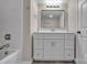 Bright bathroom featuring a white vanity with a rectangular mirror, and shower with tub at 132 Riverview Acres Ln, Taylorsville, NC 28681
