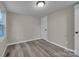 Cozy bedroom with neutral walls, updated flooring, and natural light from a side window at 132 Riverview Acres Ln, Taylorsville, NC 28681