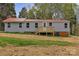 The rear exterior shows a home with vinyl siding, a red metal roof, and a wood deck at 132 Riverview Acres Ln, Taylorsville, NC 28681