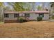 Charming single-story home with red metal roof and mature trees in a quiet wooded neighborhood at 132 Riverview Acres Ln, Taylorsville, NC 28681