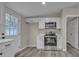 Modern kitchen featuring stainless steel appliances and white cabinetry with contemporary hardware at 132 Riverview Acres Ln, Taylorsville, NC 28681