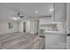 Open concept living room with gray flooring, white walls, with kitchen to the side at 132 Riverview Acres Ln, Taylorsville, NC 28681