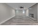 Spacious living room boasts fresh paint, new flooring, large fireplace, and a ceiling fan at 132 Riverview Acres Ln, Taylorsville, NC 28681