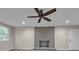 The living room has a brick fireplace, ceiling fan, fresh paint, and modern flooring at 132 Riverview Acres Ln, Taylorsville, NC 28681