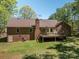 The home has a spacious backyard featuring a wooden deck, brick exterior and well-maintained lawn at 1478 Smith Farm Rd, Lincolnton, NC 28092