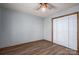 A simple bedroom features laminate floors, a ceiling fan, and closet at 1478 Smith Farm Rd, Lincolnton, NC 28092