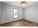 This bedroom features hardwood floors, a ceiling fan, and a window with natural light at 1478 Smith Farm Rd, Lincolnton, NC 28092