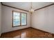 Dining area featuring hardwood floors, wood trim, a modern chandelier, and a window view to the outdoors at 1478 Smith Farm Rd, Lincolnton, NC 28092