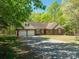 Charming brick home featuring an attached three-car garage and long driveway nestled among beautiful trees at 1478 Smith Farm Rd, Lincolnton, NC 28092
