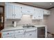 Traditional style kitchen with white cabinets, stainless steel appliances, light counters, and wood-look flooring at 1478 Smith Farm Rd, Lincolnton, NC 28092