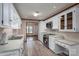 Traditional style kitchen with white cabinets, stainless steel appliances, light counters, and wood-look flooring at 1478 Smith Farm Rd, Lincolnton, NC 28092