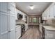 Traditional style kitchen with white cabinets, stainless steel appliances, light counters, and wood-look flooring at 1478 Smith Farm Rd, Lincolnton, NC 28092