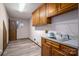 Laundry room featuring wood cabinets, sink, wire rack and door at 1478 Smith Farm Rd, Lincolnton, NC 28092