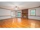 Living room with hardwood floors, fireplace, ceiling fan, and slider to the back at 1478 Smith Farm Rd, Lincolnton, NC 28092