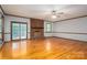 Spacious living room with hardwood floors, a brick fireplace, a ceiling fan and sliding glass doors to the back at 1478 Smith Farm Rd, Lincolnton, NC 28092