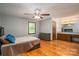 Bright main bedroom features wood floors, a ceiling fan and attached vanity at 1478 Smith Farm Rd, Lincolnton, NC 28092