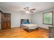 Bedroom with wood floors, ceiling fan, window and a door in the background at 1478 Smith Farm Rd, Lincolnton, NC 28092