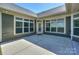 Spacious back patio featuring neutral siding and bright windows overlooking the yard at 14917 Dewpoint Pl, Huntersville, NC 28078