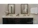 Elegant bathroom featuring double sinks, stylish vanities, and modern fixtures, providing a spa-like experience at 14917 Dewpoint Pl, Huntersville, NC 28078