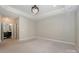 Spacious bedroom with tray ceiling, recessed lighting and neutral carpeting at 14917 Dewpoint Pl, Huntersville, NC 28078