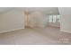 Spacious bonus room with neutral carpet, recessed lighting and natural light from the window at 14917 Dewpoint Pl, Huntersville, NC 28078