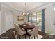 Dining room features an elegant chandelier, large window, and hardwood floors, perfect for Gathering meals and entertaining at 14917 Dewpoint Pl, Huntersville, NC 28078