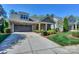 Beautiful exterior featuring stone accents, a gray garage door and well-maintained landscaping at 14917 Dewpoint Pl, Huntersville, NC 28078