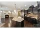 Open concept layout of the kitchen and living room featuring a cozy fireplace at 14917 Dewpoint Pl, Huntersville, NC 28078