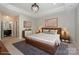 Stylish main bedroom showcases modern decor, tray ceiling, and comfortable layout, perfect for relaxation at 14917 Dewpoint Pl, Huntersville, NC 28078