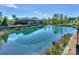 Scenic community pond with green space and residential buildings in the background at 14917 Dewpoint Pl, Huntersville, NC 28078