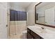 Cozy bathroom with a shower curtain, stylish mirror, and clean finishes at 1518 Sylvia Ct, Charlotte, NC 28205