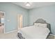 Primary bedroom suite featuring a plush bed and ensuite bathroom at 1518 Sylvia Ct, Charlotte, NC 28205