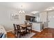 The dining area features modern lighting and is open to the kitchen and living room at 1518 Sylvia Ct, Charlotte, NC 28205