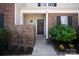 Close up of the entryway of the townhome, showing a small brick wall at 1518 Sylvia Ct, Charlotte, NC 28205