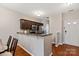Eat-in kitchen features stainless steel appliances, a breakfast bar, and hardwood floors at 1518 Sylvia Ct, Charlotte, NC 28205