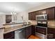 Well-equipped kitchen features stainless steel appliances, granite countertops, and dark wood cabinetry at 1518 Sylvia Ct, Charlotte, NC 28205