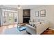 Bright living room features a fireplace, hardwood floors, and French doors to the patio at 1518 Sylvia Ct, Charlotte, NC 28205