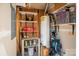 Storage room featuring shelving, water heater, paint cans, and storage space, perfect for organization at 1518 Sylvia Ct, Charlotte, NC 28205