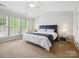 Primary bedroom with ceiling fan, carpet, and large windows at 15643 Canmore St, Charlotte, NC 28277