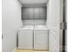 Convenient laundry room with modern washer and dryer, upper cabinets for storage, and tile flooring at 15643 Canmore St, Charlotte, NC 28277