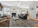 Spacious living room with fireplace, hardwood floors, and a modern ceiling fan at 15643 Canmore St, Charlotte, NC 28277