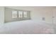 Large bonus room with neutral carpet, a large window, and a closet, offering plenty of space and flexibility at 1996 Copper Path Dr, Fort Mill, SC 29715