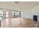 Bright living room with wood floors, a fireplace, and large windows offers an inviting atmosphere and lots of sunlight at 1996 Copper Path Dr, Fort Mill, SC 29715