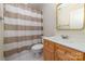 Bathroom with a shower-tub combo, vanity with great storage, and a large mirror at 20015 N Cove Rd, Cornelius, NC 28031
