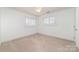 Neutral toned bedroom with great natural light from windows and a ceiling fan at 20015 N Cove Rd, Cornelius, NC 28031