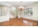 Bright dining room featuring hardwood floors, white trim, and a decorative chandelier at 20015 N Cove Rd, Cornelius, NC 28031