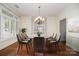Elegant dining room with a stylish chandelier and large windows with shutters at 20015 N Cove Rd, Cornelius, NC 28031