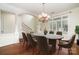 Well-lit dining room featuring a modern chandelier and views to the stairwell at 20015 N Cove Rd, Cornelius, NC 28031
