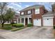 Beautiful two-story brick home featuring a front porch and attached two-car garage at 20015 N Cove Rd, Cornelius, NC 28031